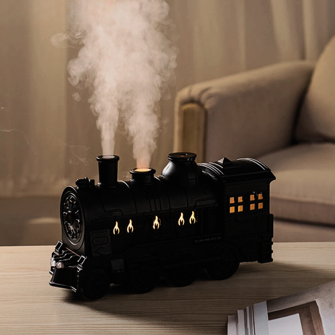 Retro-style small train aromatherapy humidifier in train black with remote control, featuring a large fog spray, dual mist outlets, and a square desktop design