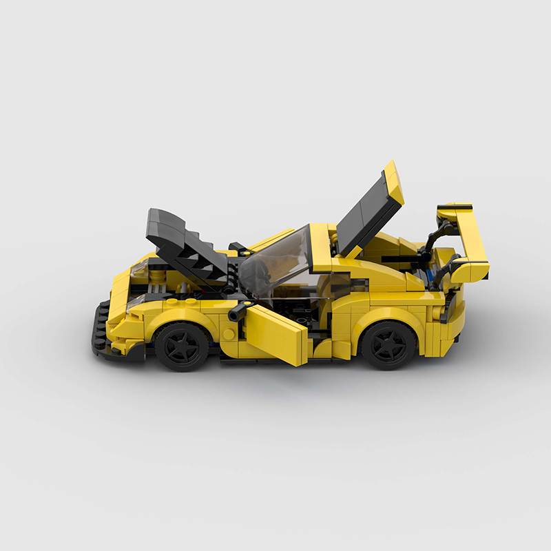 Vibrant yellow Keisuke Mazda RX-7 building blocks set, made from eco-friendly ABS plastic, compatible with Lego, measuring approximately 17 x 8 x 5 cm