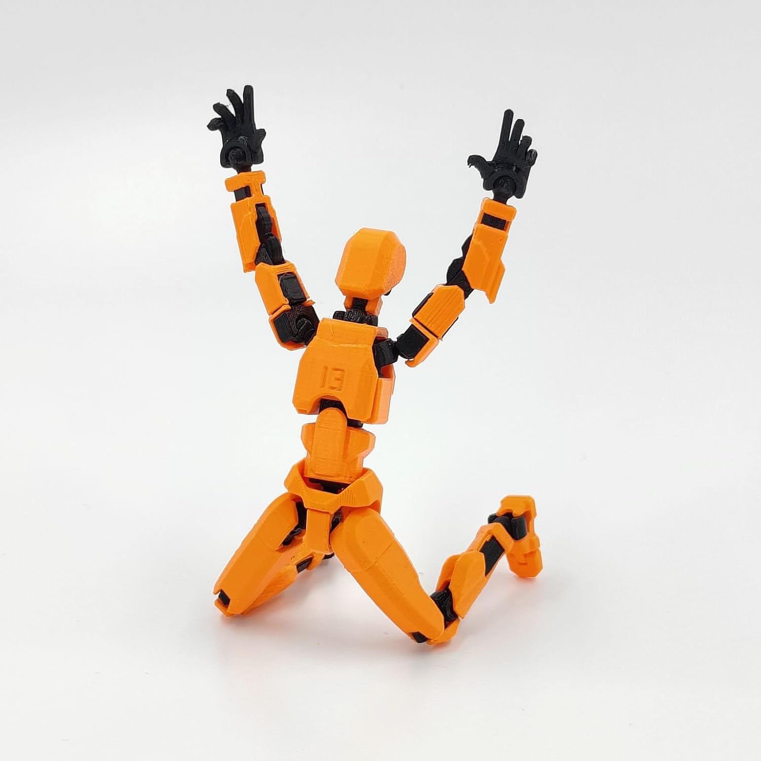 Articulated red robot action figure with multiple joints, made of durable plastic, measuring approximately 4 x 17 x 2 cm.