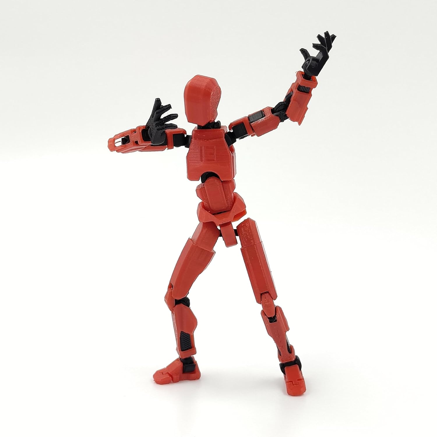 Articulated red robot action figure with multiple joints, made of durable plastic, measuring approximately 4 x 17 x 2 cm.