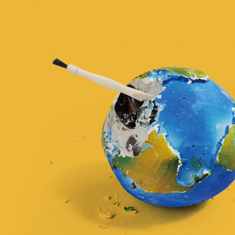 Children's excavation toy set with a planet model, excavation tools, brush, gemstones/fossils, and an educational poster designed for STEM learning