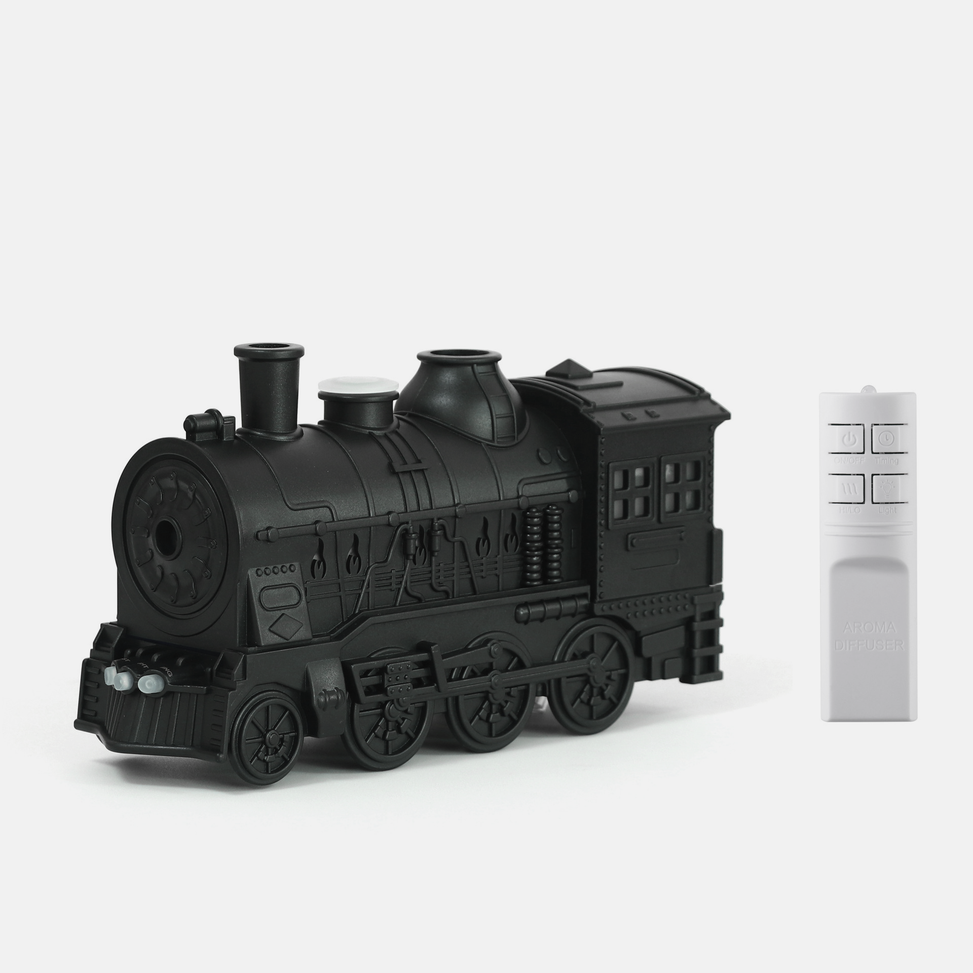 Retro-style small train aromatherapy humidifier in train black with remote control, featuring a large fog spray, dual mist outlets, and a square desktop design